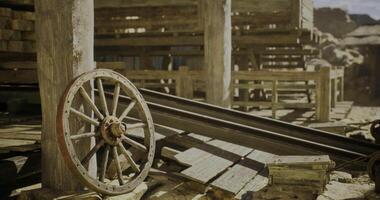 CGI Old wooden wheel resting beside wooden structures in a rustic setting video