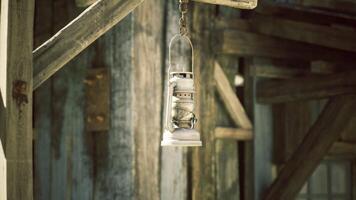 CGI Classic hanging lantern illuminates rustic wooden structure in daylight video