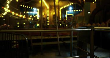 CGI Colorful carousel at night with sparkling lights and empty waiting area video