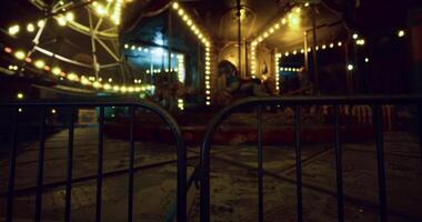 CGI Eerie carnival at night with illuminated carousel and empty rides video