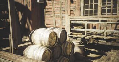 CGI Wooden barrels stacked outside a rustic building under warm sunlight video