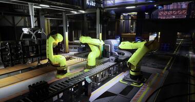 CGI High tech robotic arms work on an assembly line in a modern factory setting video