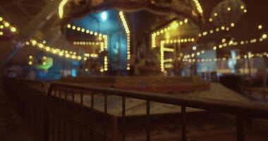 CGI Nighttime carnival atmosphere illuminated with colorful lights and music video