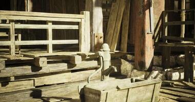 CGI Rustic wooden water pump in a rural setting with aged structures video