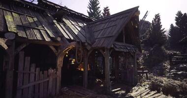 CGI Old rustic building surrounded by trees during the day in a forest video