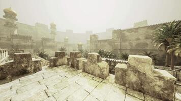 CGI Ancient fortress courtyard with palm trees under misty sky video