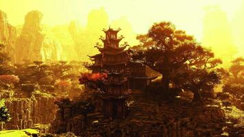 CGI Ancient Chinese architecture surrounded by mystical mountains at dusk video