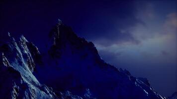CGI Snowy mountain peaks under twilight sky with dramatic lighting effects video