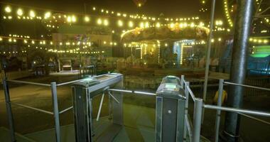 CGI Nighttime view of a carnival carousel surrounded by glowing lights and rides video