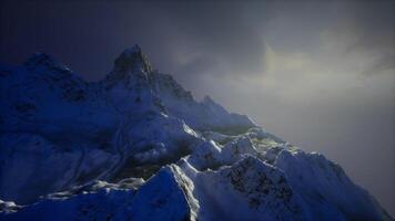 CGI Majestic snow capped mountain range during twilight hours in remote location video