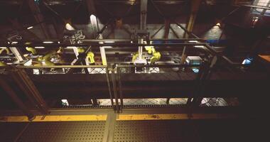 CGI Industrial automation with robotic arms in a manufacturing facility at night video