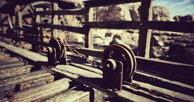 CGI Chain mechanism on wooden structure by rocky terrain under clear sky video