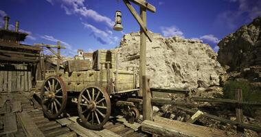 CGI Old wooden wagon resting near a rocky canyon under a bright blue sky video