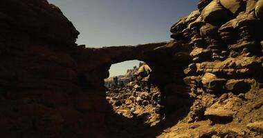 CGI Rock arch with clear blue sky in desert landscape during daylight hours video