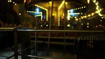 CGI An empty carousel stands illuminated in an amusement park at night video
