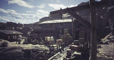 CGI Dusty old mining town with wooden structures under blue sky and clouds video