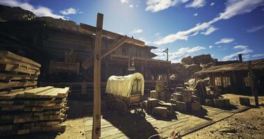 CGI Historic wooden building with wagon and crates under sunny sky in desert video