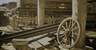 CGI Abandoned wooden cart wheel in a rustic mining town setting video