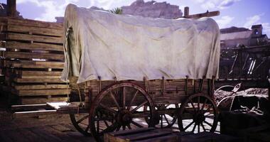 CGI Covered wooden wagon resting in a rustic outdoor setting during daylight video