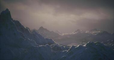 CGI Majestic mountain range with misty atmosphere under cloudy sky at dusk video