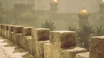 CGI Ancient stone walls with golden domes under a hazy sky at dusk video