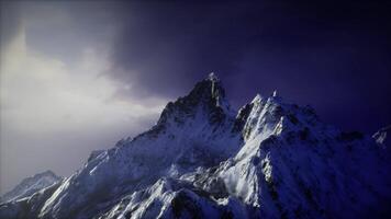 CGI Snow covered mountain peaks under dramatic twilight sky in a remote location video