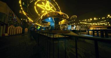 CGI Lonely carnival at night with illuminated attractions and quiet ambiance video