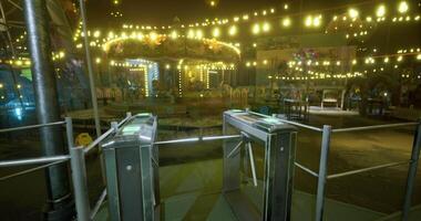 CGI Colorful carnival at night with illuminated carousel and entrance turnstiles video