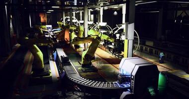 CGI Advanced robotics at work in a modern factory during evening hours video