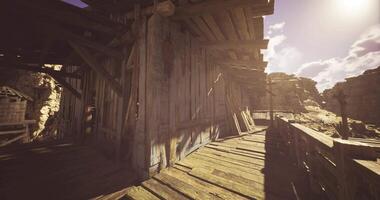 CGI Deserted wooden structure along a dusty path in a remote canyon video