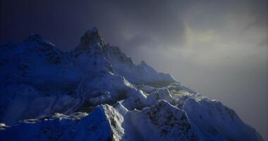 CGI Snow capped mountain peak under twilight sky with dramatic lighting video