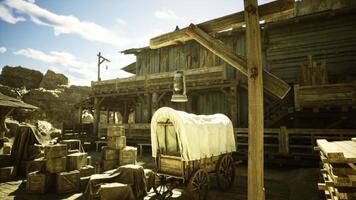 CGI Rustic western town with wooden structures and wagon under bright sky video