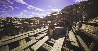 CGI Dusty old wooden platform with a heavy covered item in rugged terrain video