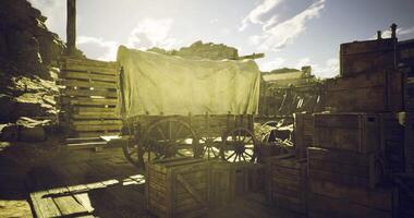 CGI Old wooden wagon in a dusty frontier setting with wooden crates nearby video