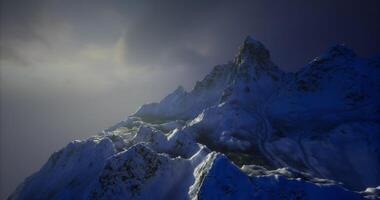 CGI Majestic snowy mountain peaks under a cloudy sky during twilight hours video