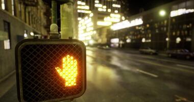 CGI City pedestrian signal displaying stop hand at night in urban setting video