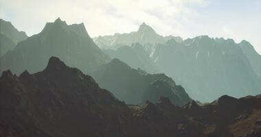 CGI Mountains rise majestically under a clear sky in a serene landscape view video