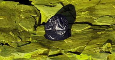 CGI Trash bag on yellow rocks shows waste management issues video