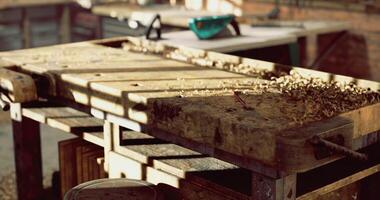 CGI Woodworking tools and shavings on a rustic workbench during daylight hours video