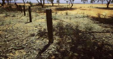 CGI Dry landscape with barbed wire fence in a remote area during midday video