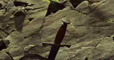 CGI Sword embedded in rocky terrain with a rustic atmosphere at dusk video