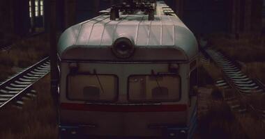 CGI Vintage train travels through overgrown railway in twilight setting video
