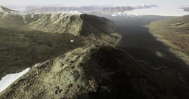 CGI Scenic view of rugged mountain landscape with snow and lake in distant horizon video