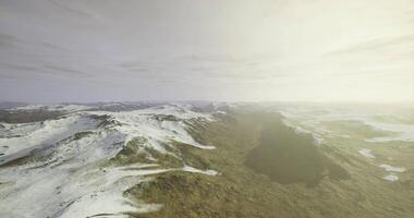 CGI Expansive view of snow capped mountains under a soft golden light video