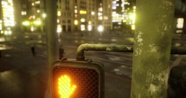 CGI Bright orange pedestrian signal indicates stop in urban setting during night video