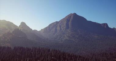 CGI Majestic mountain view with lush forests under clear blue sky during daytime video