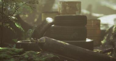 CGI Old tires and rusted containers create a mysterious scene in the forest video