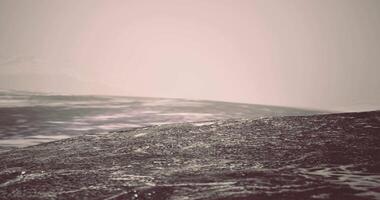 CGI Waves gently rolling on a misty ocean at sunrise over tranquil waters video
