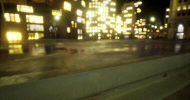 CGI City at night with illuminated buildings reflecting on wet pavement video