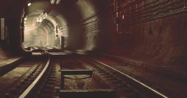 CGI Mysterious underground railway tunnel with tracks and dim lighting video